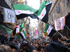 Secular demonstrators, shown at a protest march this month in Aleppo, wave the old Syrian flag (green, white, black and red) that has become the symbol of their opposition movement. Secular demonstrators, shown at a protest march this month in Aleppo, wave the old Syrian flag (green, white, black and red) that has become the symbol of their opposition movement.