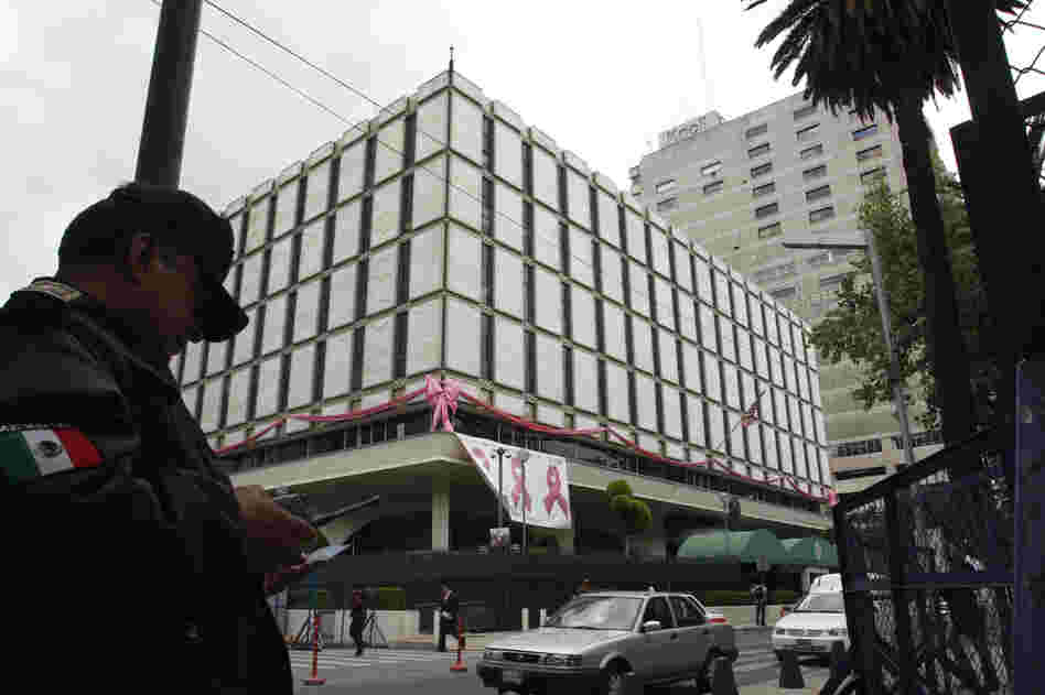 A policeman stands in front of the U.S. Embassy in Mexico City in 2008. This embassy was built in 1961 and is more in line with the fortress-style embassies.