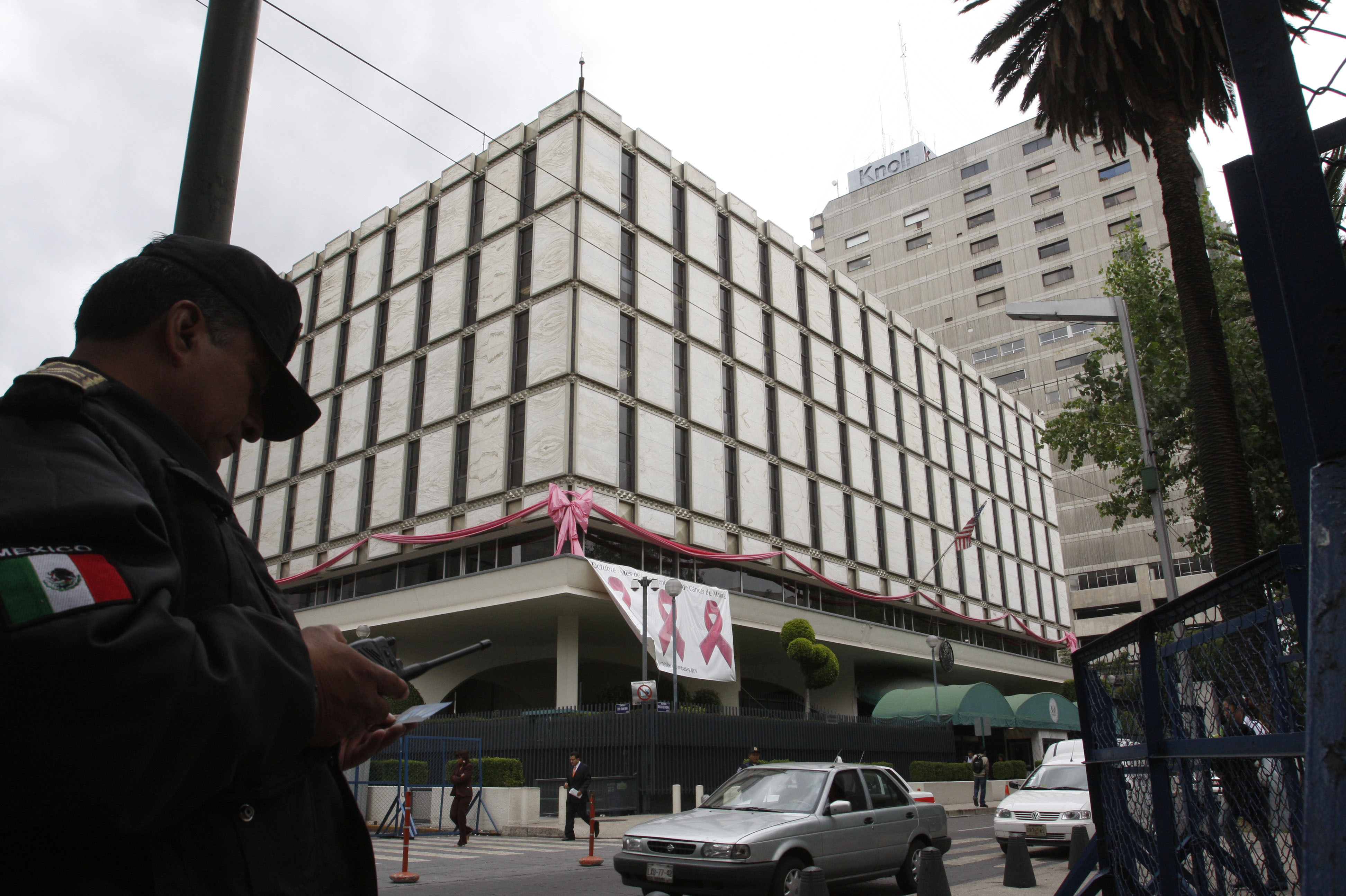 A policeman stands in front of the U.S. Embassy in Mexico City in 2008. This embassy was built in 1961 and is more in line with the fortress-style embassies.