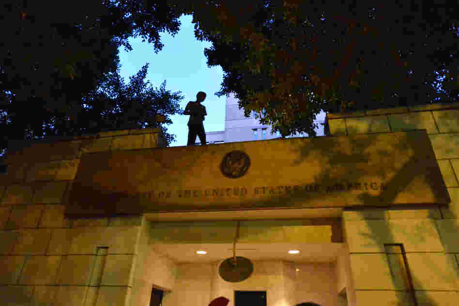 An Egyptian protester stands above the entry of the U.S. Embassy in Cairo on Sept. 11, 2012, during a demonstration against a film deemed offensive to Islam.