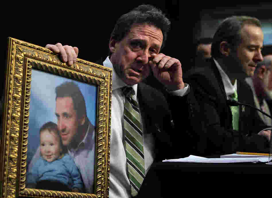 Neil Heslin, father of six-year-old Sandy Hook Elementary School shooting victim Jesse Lewis, holds a picture of him with Jesse as he testifies during a hearing before the Senate Judiciary Committee on Wednesday.