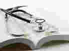 stethoscope on open book on a white background