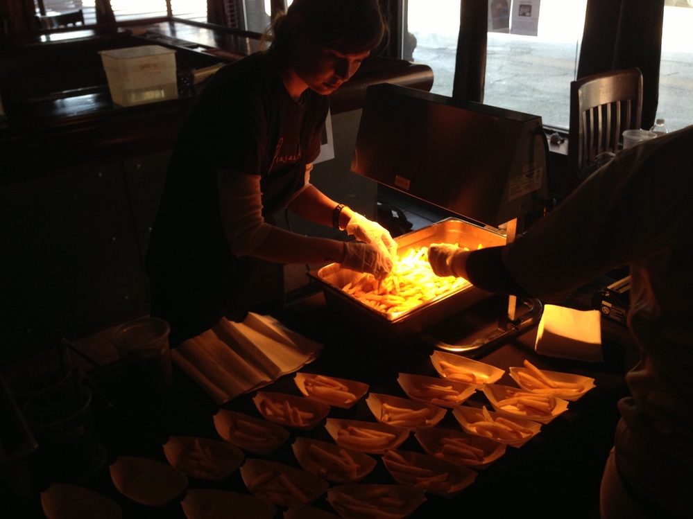 Missy Ruminski prepares The Peasantry's entry. Note that poutine is not only a delicious snack but also a source of light and warmth in the universe.