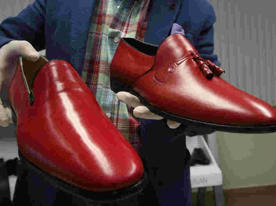 Armando Martin Dueñas shows replicas of the hand-crafted loafers given to Pope Benedict XVI.