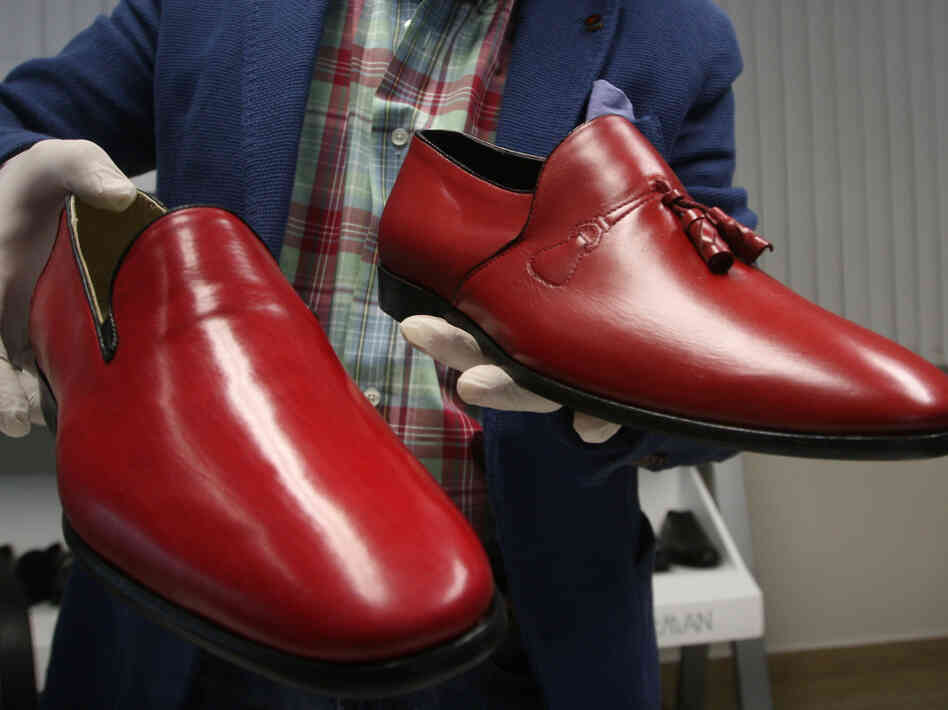 Armando Martin Dueñas shows replicas of the hand-crafted loafers given to Pope Benedict XVI.