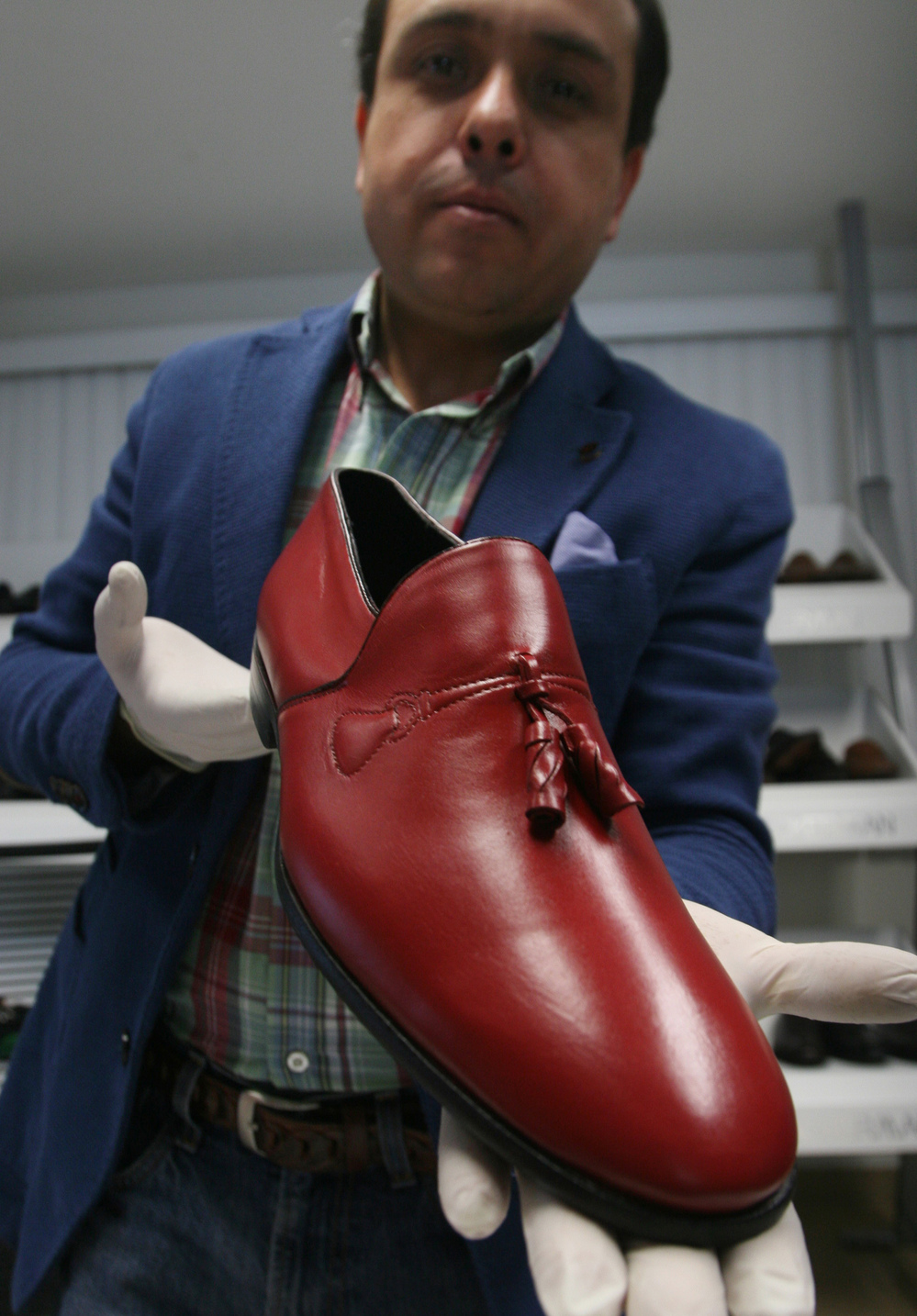 Armando Martin Dueñas shows a replica of one of the hand-crafted loafers that were given to Pope Benedict XVI during his March 2012 visit to Mexico at the Ackerman shoe factory in Leon, Mexico.