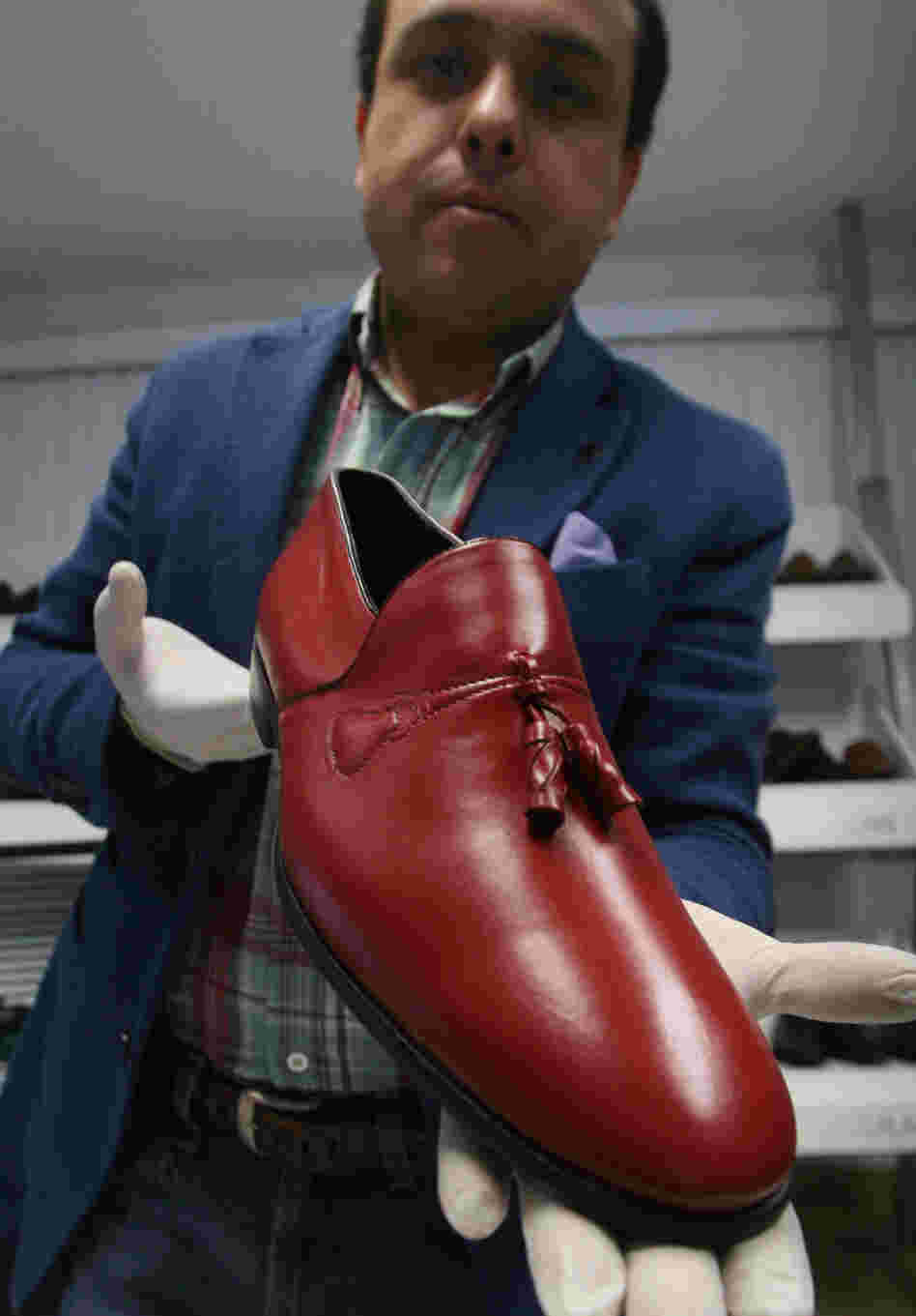 Armando Martin Dueñas shows a replica of one of the hand-crafted loafers that were given to Pope Benedict XVI during his March 2012 visit to Mexico at the Ackerman shoe factory in Leon, Mexico.