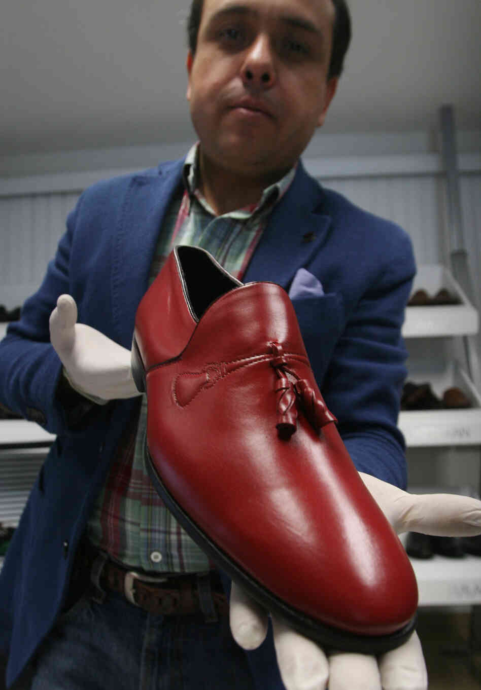 Armando Martin Dueñas shows a replica of one of the hand-crafted loafers that were given to Pope Benedict XVI during his March 2012 visit to Mexico at the Ackerman shoe factory in Leon, Mexico.