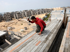 A Palestinian laborer works at the site of a residential construction project funded by the United Nations Relief and Works Agency for Palestine Refugees in Rafah, in the southern Gaza Strip, on Mar. 21, 2012. A Palestinian laborer works at the site of a residential construction project funded by the United Nations Relief and Works Agency for Palestine Refugees in Rafah, in the southern Gaza Strip, on Mar. 21, 2012.