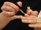A worker paints fingernails with O2M polish at an Inglot shop in a Polish shopping center. The breathable nail polish has become a hit with Muslim women.