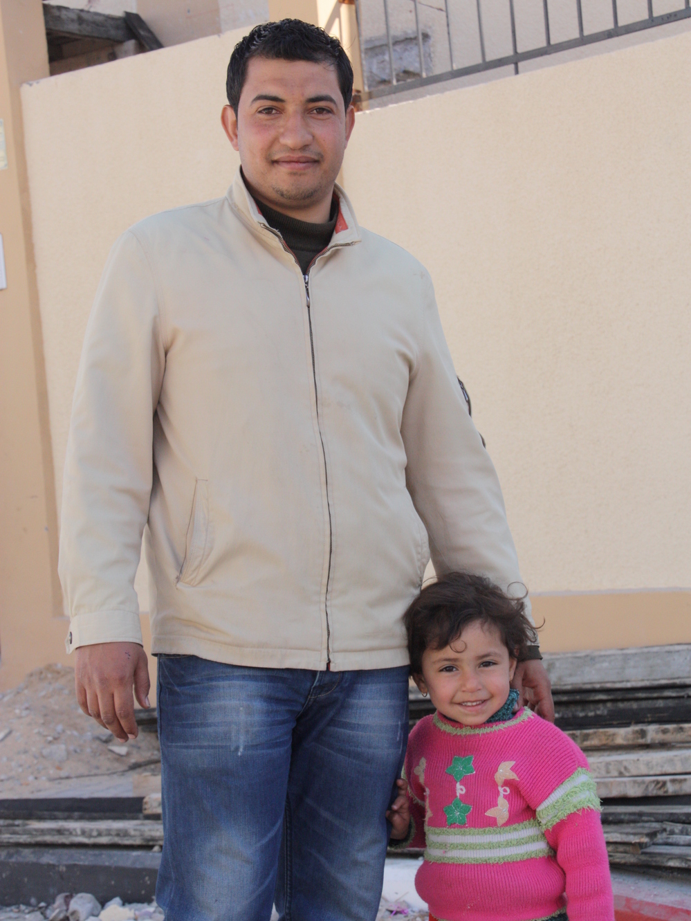 Waji el Jebaley and his daughter stand in front of their newly constructed home in Rafah, a town at the southern edge of the Gaza Strip, on Feb. 20.