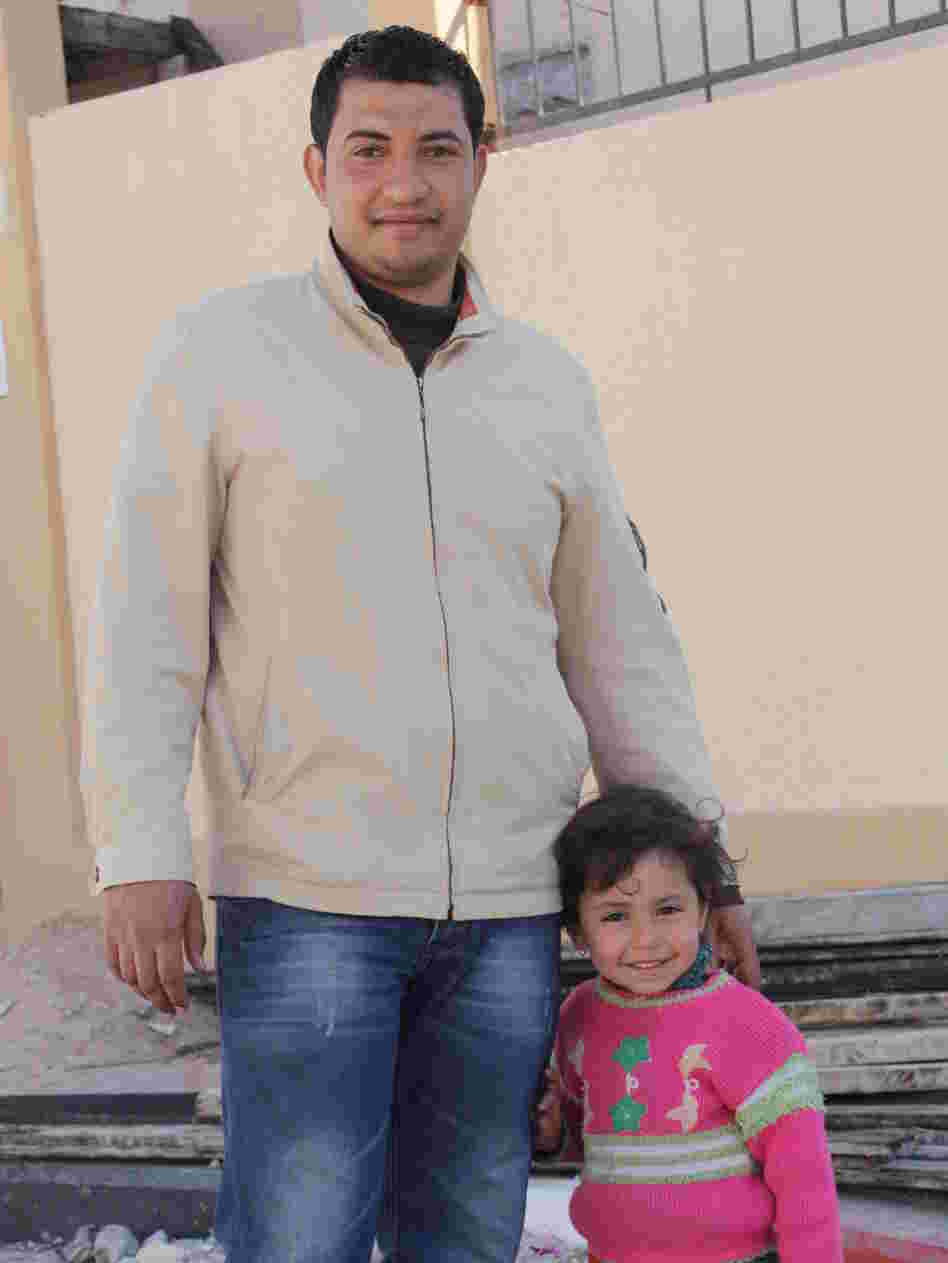 Waji el Jebaley and his daughter stand in front of their newly constructed home in Rafah, a town at the southern edge of the Gaza Strip, on Feb. 20.