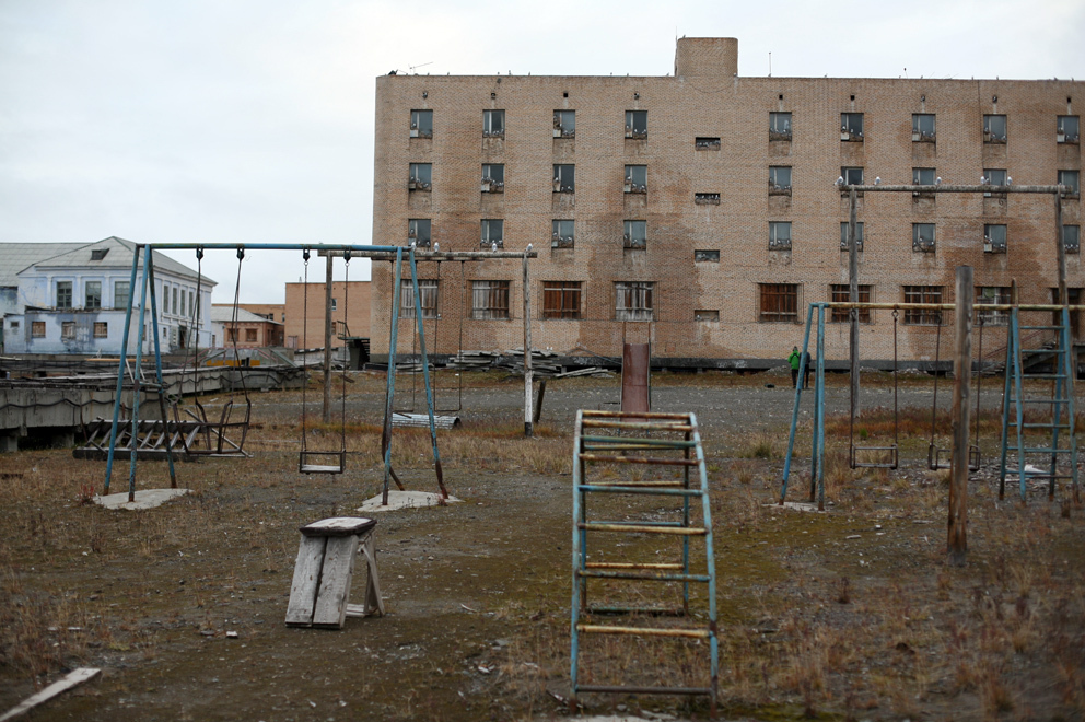 Empty buildings and rusty swing sets in the town of Piramida. The Russian mining colony that built and populated the settlement abandoned it in 1998.