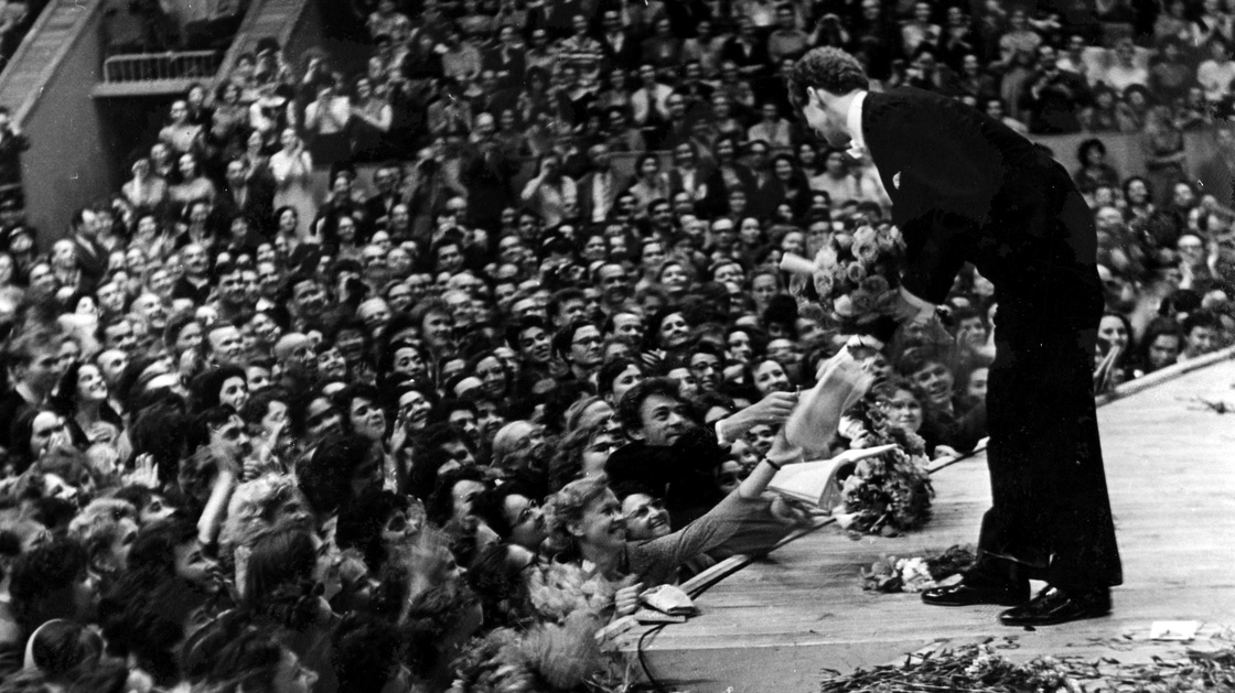 Van Cliburn accepts flowers from the audience in the Moscow Conservatory in April 1958, after a performance during the first International Tchaikovsky Competition, which he won.