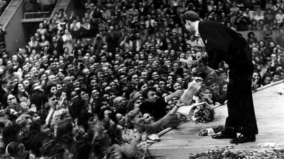 Van Cliburn accepts flowers from the audience in the Moscow Conservatory in April 1958, after a performance during the first International Tchaikovsky Competition, which he won.