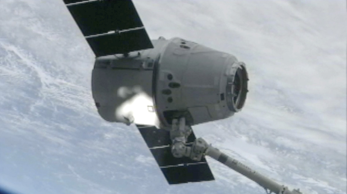 The SpaceX Dragon cargo vehicle is grappled by the International Space Station's robotic arm Sunday morning.