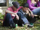 Cousin Kyle Balcom (L) and brother Dustin Bush console each other after the disappearance of Jeffrey Bush into a Seffner, Florida, sinkhole.