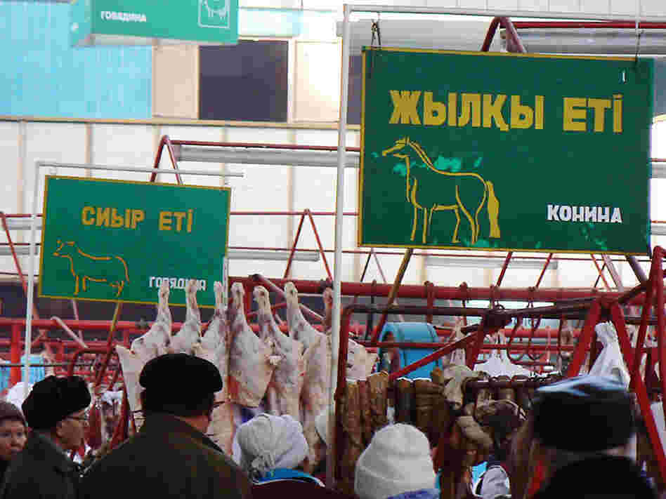 Signs advertise the type of meat sold in each section of the Green Market in Almaty, Kazakhstan.