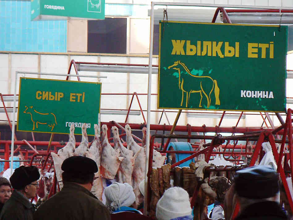 Signs advertise the type of meat sold in each section of the Green Market in Almaty, Kazakhstan.