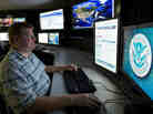 An analyst works at a federal cybersecurity center in Idaho in 2011. Experts say Internet-connected infrastructure is a possible target of cyberwarfare.