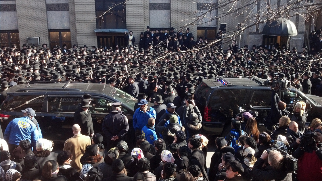 Mourners lined the street Sunday outside a synagogue in Brooklyn where funeral services were held for Raizy and Nathan Glauber.