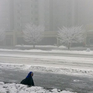 "A North Korean woman walks in snowstorm in #Pyongyang. An iPod touch photo from Jan. 13, 2013."
