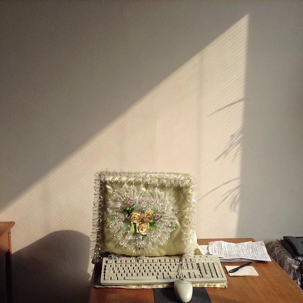 "A frilly dust cover protects a desktop computer inside a #Pyongyang, North Korea office."