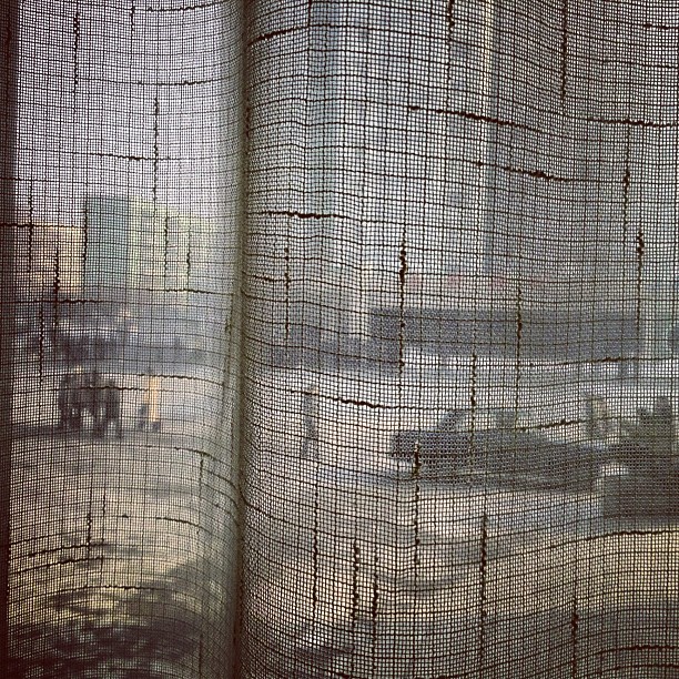 "North Koreans walk along a #Pyongyang street seen through a coffee shop window curtain on January 8, 2013."