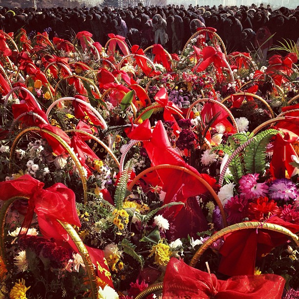 "Offerings of flowers are lined up on Mansu Hill as North Koreans bow in front of bronze statues of their late leaders. Today would have been the 71st birthday of Kim Jong Il, who died in Dec., 2011."