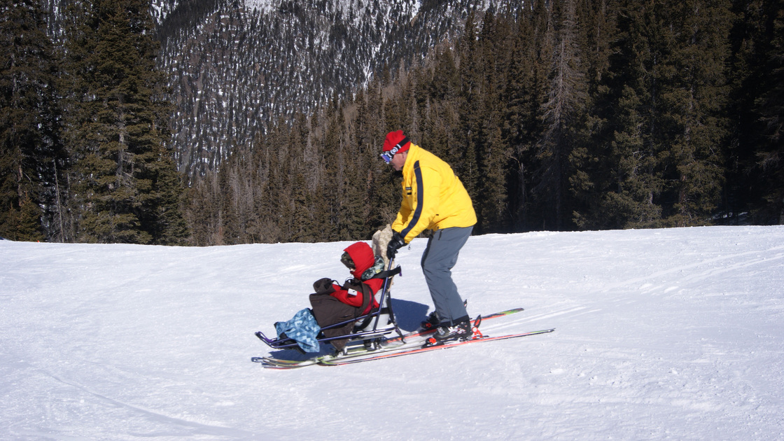 Tilghman Logan and his instructor, Craig Stagg, do some practice turns using sit skis. Some ski resorts have created opportunities for people with disabilities to participate in snow sports.