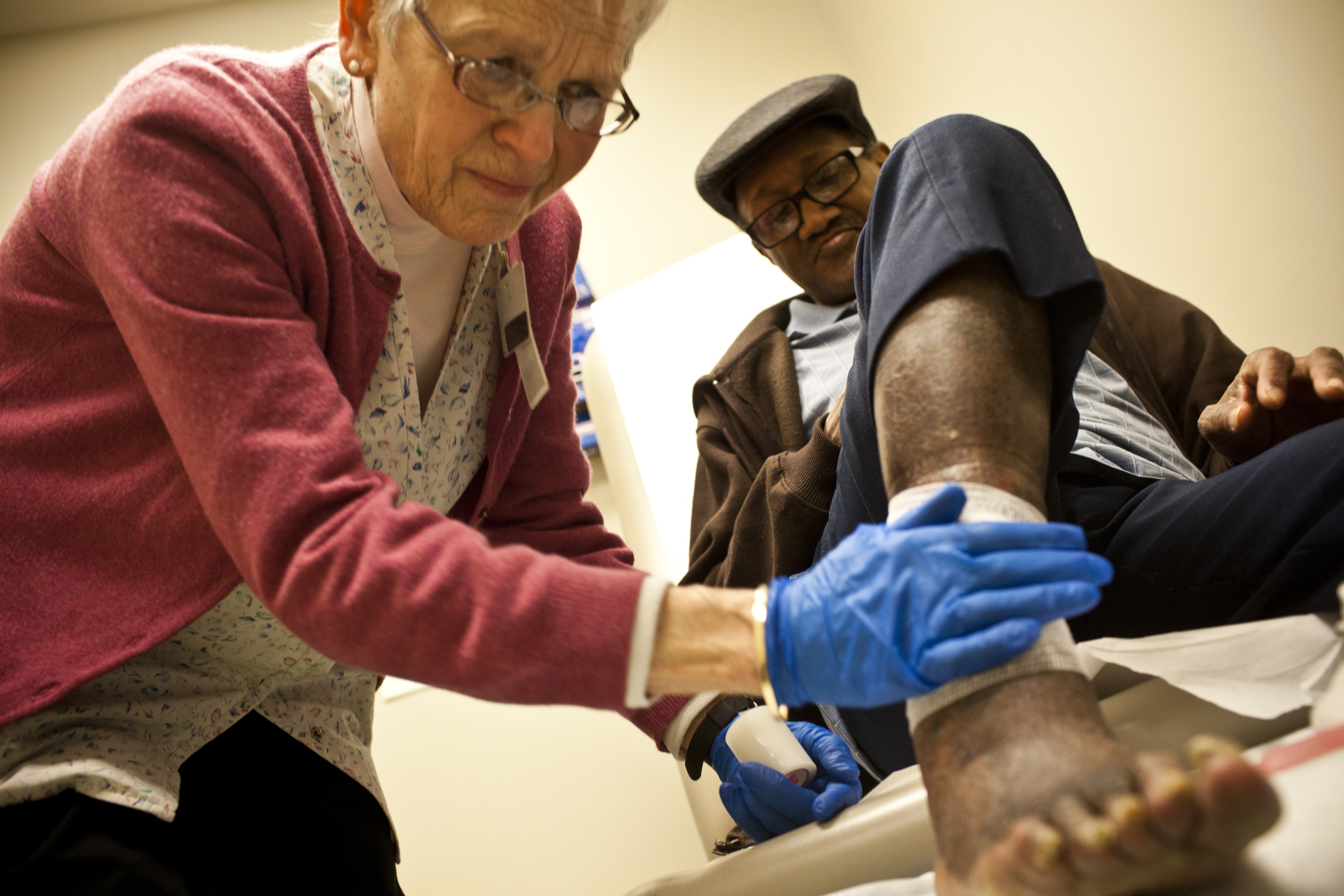 HCH also runs a convalescent floor in a nearby shelter where patients can recover from fractures or recent surgeries. Susan Zator, a community nurse for more than 41 years, bandages 66-year-old William Jones' foot injury. Zator says this service is vital for homeless men and women who cannot recover properly while living on the street.