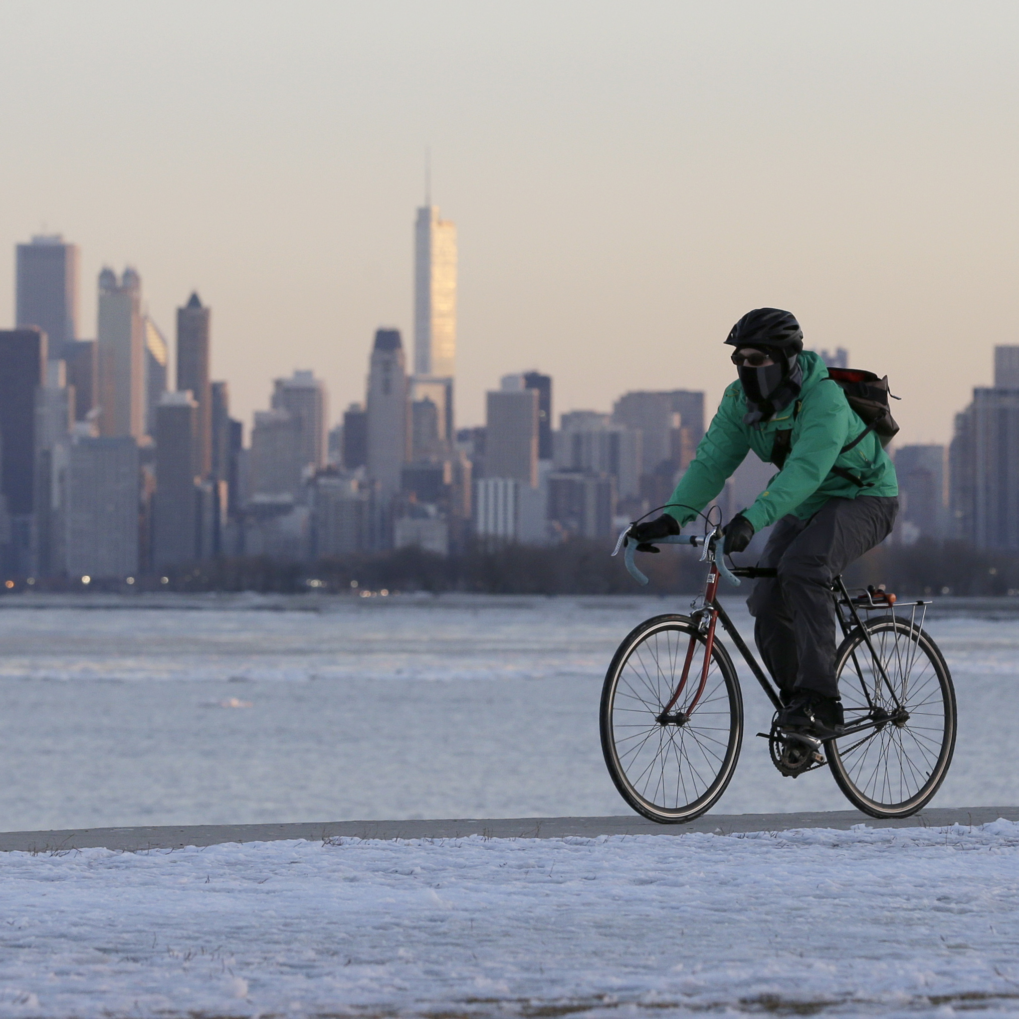 Bundled up: A biker in Chicago this weekend. The city is in the crosshairs of the storm that's going to dump snow across much of the nation.