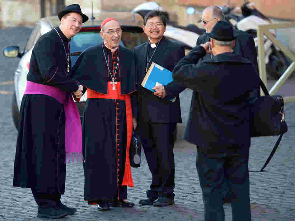 That's not a real bishop on the left: A man later identified as Ralph Napierski of Germany (at left) posed with Cardinal Sergio Sebiastiana and others on Monday at the Vatican. Napierski was an imposter. He was later escorted from the area by Swiss Guards.