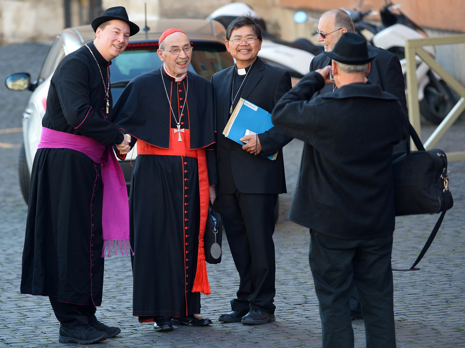 That's not a real bishop on the left: A man later identified as Ralph Napierski of Germany (at left) posed with Cardinal Sergio Sebiastiana and others on Monday at the Vatican. Napierski was an imposter. He was later escorted from the area by Swiss Guards.