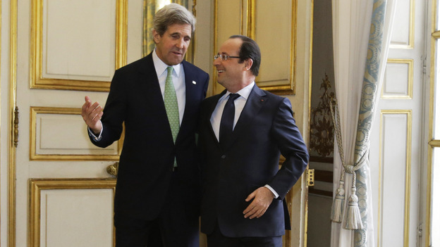 John Kerry, on his first trip abroad as secretary of state, walks with French President Francois Hollande after their meeting at Elysee Palace in Paris on Feb. 27. Kerry's nine-day trip took him through Europe and the Middle East. (AP)