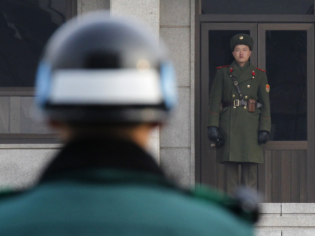 A North Korean (right) and a South Korean soldier facing  each other at the Panmunjom truce village in the demilitarized zone (DMZ) separating the two Koreas in Paju, about 30 miles north of Seoul. (2011 file photo.)
