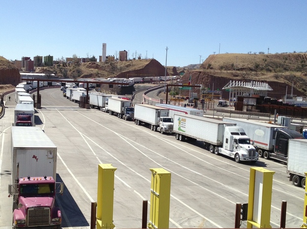 Lanes of trucks wait to cross the border from Mexico into Nogales, Ariz. Fallout from the sequester could increase wait times for perishable cargo.