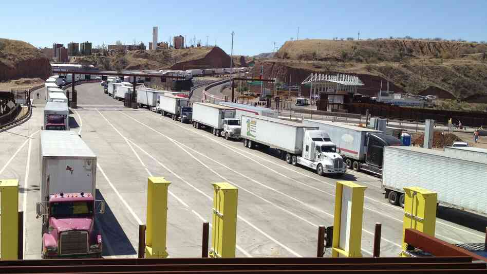 Lanes of trucks wait to cross the border from Mexico into Nogales, Ariz. Fallout from the sequester could increase wait times for perishable cargo.