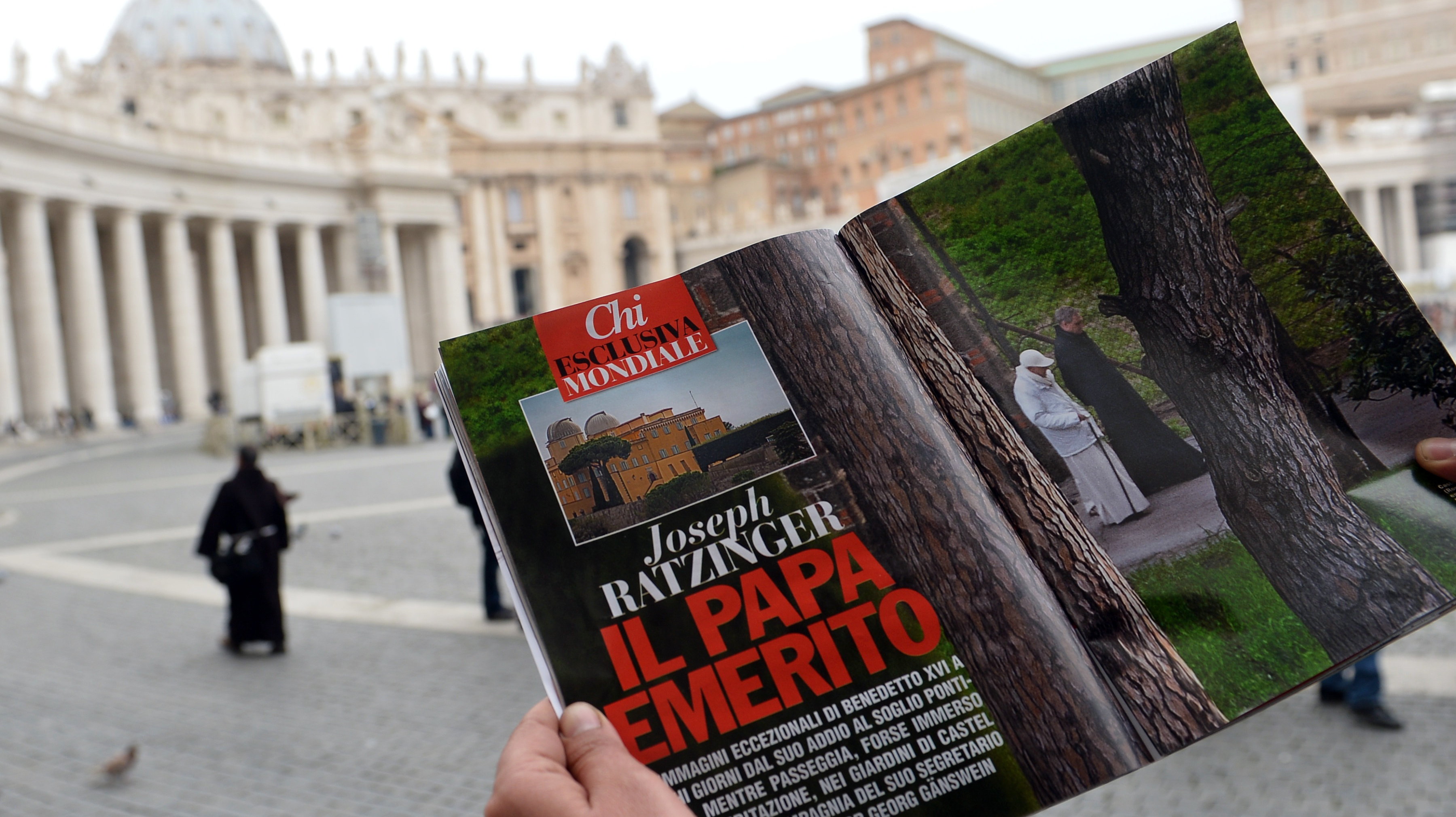 In Vatican City's St. Peter's Square on Wednesday, a man looked at  the Italian magazine <em>Chi</em>'s photo of former Pope Benedicxt XVI — the first such image since he stepped down last week.