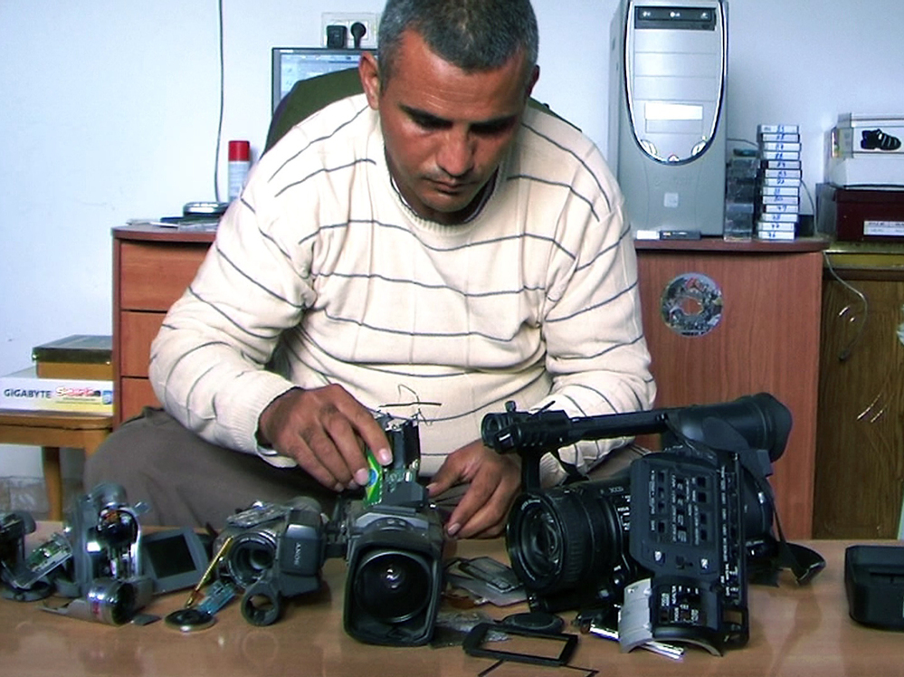Emad Burnat, a Palestinian who co-directed the Oscar-nominated documentary 5 Broken Cameras, displays the cameras destroyed by Israeli settlers and security forces.