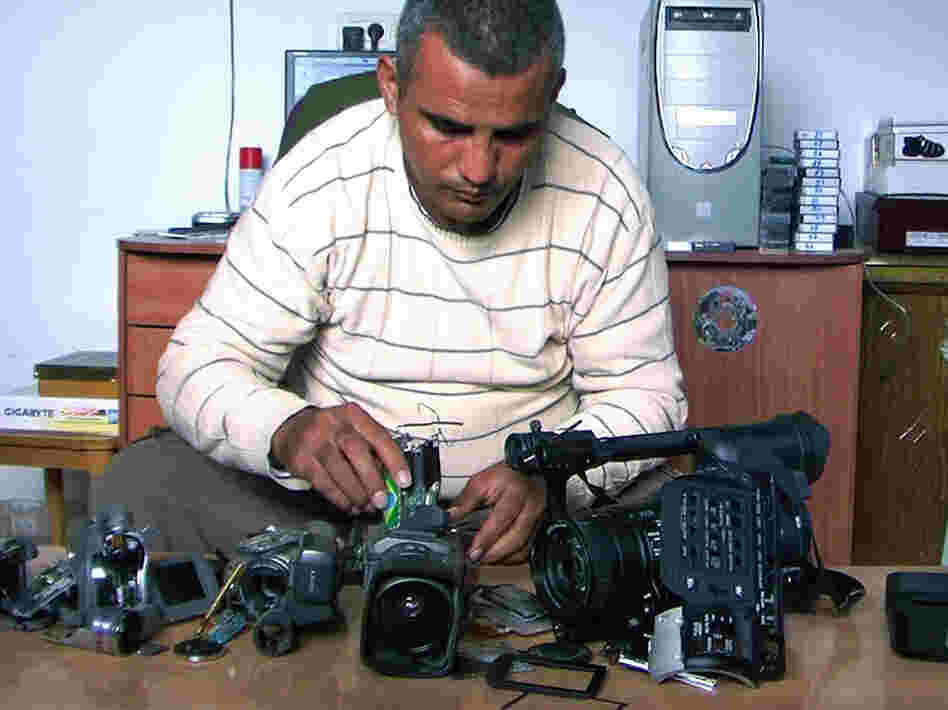 Emad Burnat, a Palestinian who co-directed the Oscar-nominated documentary 5 Broken Cameras, displays the cameras destroyed by Israeli settlers and security forces.
