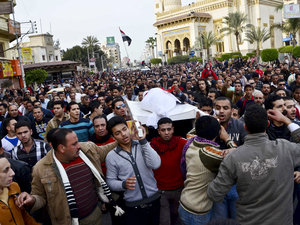 Egyptians carry the body of a person killed in clashes between police and protesters in Mansura on March 2. Mansura is the latest province to launch a campaign of civil disobedience, following in the footsteps of the canal cities of Port Said, Ismailiya and Suez.