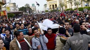 Egyptians carry the body of a person killed in clashes between police and protesters in Mansura on Saturday. Mansura is the latest province to launch a campaign of civil disobedience, following in the footsteps of the canal cities of Port Said, Ismailiya and Suez.