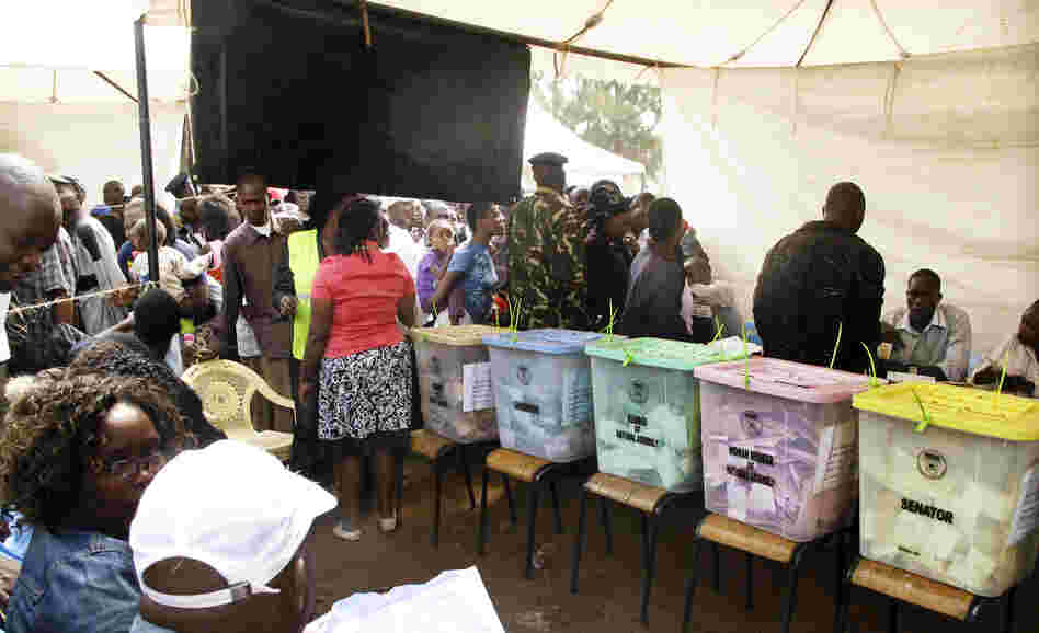 Kenyan election observers and voters in the mixed slum of Kiambiu — where the first fires started in Nairobi after the disputed presidential election of 2007 — vote in this year's elections. Could something as innocent as the color of the ballots and ballot boxes be contributing to voting "irregularities"?