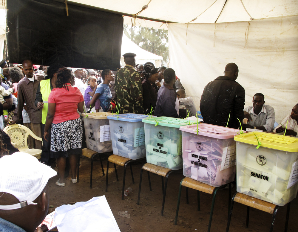 Kenyan election observers and voters in the mixed slum of Kiambiu — where the first fires started in Nairobi after the disputed presidential election of 2007 — vote in this year's elections. Could something as innocent as the color of the ballots and ballot boxes be contributing to voting "irregularities"?