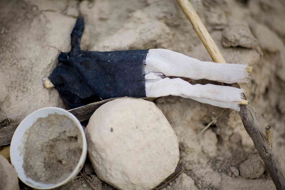 Doll, Rock, Bowl, 2009. Food may be left alongside other offerings.