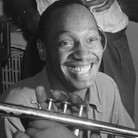 Tadd Dameron (smiling at center) was an important figure in American jazz and bebop. He is shown here with Fats Navarro on trumpet, and Charlie Rouse and Ernie Henry on saxophone.