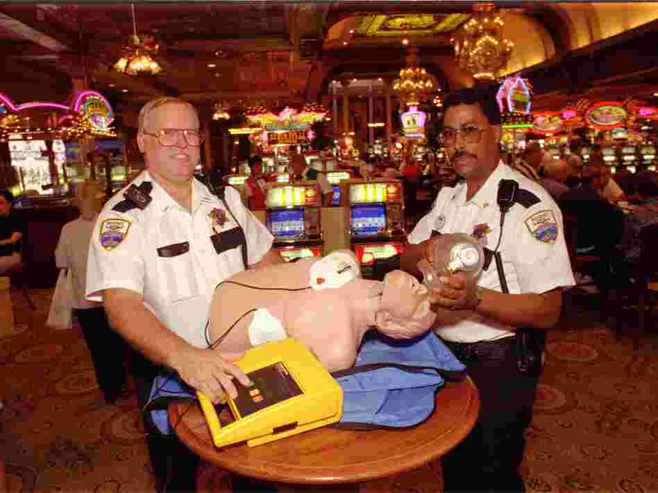 Main Street Station casino security staffers Jim Daugherty (left) and James Boles show off an automated external defibrillator in Las Vegas in 1997. Back then, the idea of putting the devices in casinos to save lives seemed like a long shot.