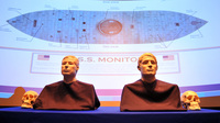 The facial reconstructions of two sailors whose remains were discovered inside the gun turret of the USS Monitor after it was raised from the ocean floor in 2002 are revealed during a 2012 ceremony.