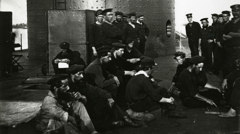 In this undated photograph provided by Naval History and Heritage Command, the crew of USS Monitor relax just outside of its turret.